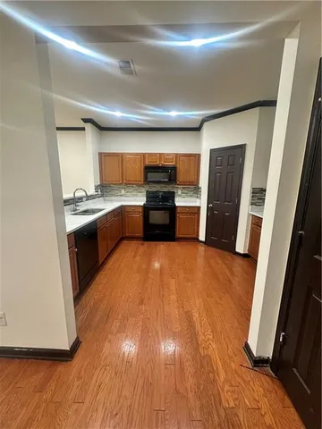 a kitchen with stainless steel appliances granite countertop a refrigerator and a stove top oven