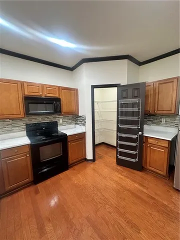 a kitchen with stainless steel appliances and granite countertop wooden cabinets
