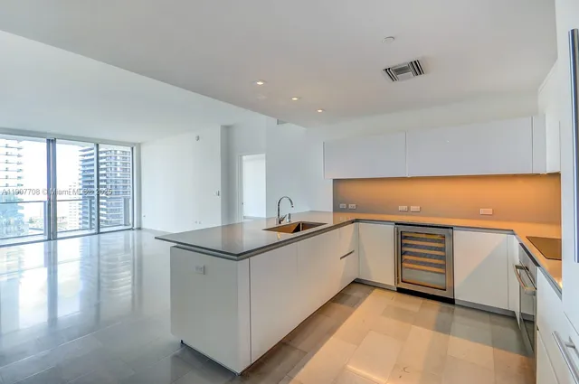 a kitchen with appliances a sink and cabinets