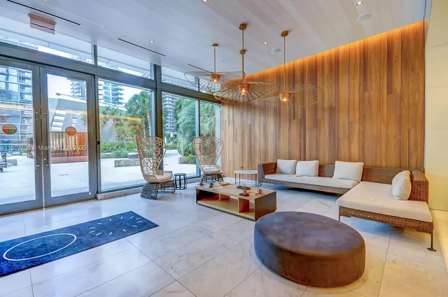 a living room with furniture and large windows