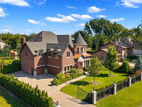 an aerial view of a house with swimming pool patio and outdoor seating