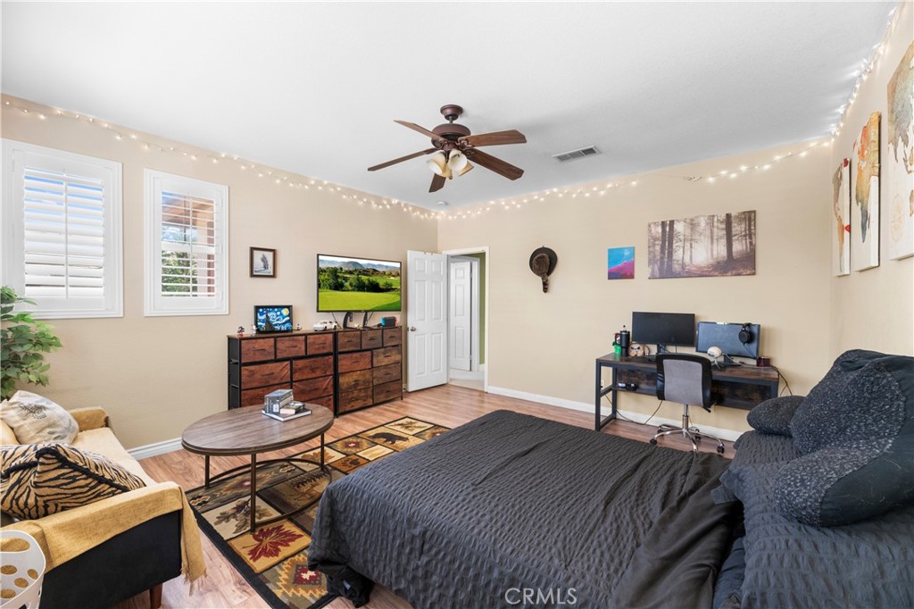 43312 Dodaro Drive Temecula, CA 92592 - Photo 40 of 58 a living room with furniture and a wooden floor