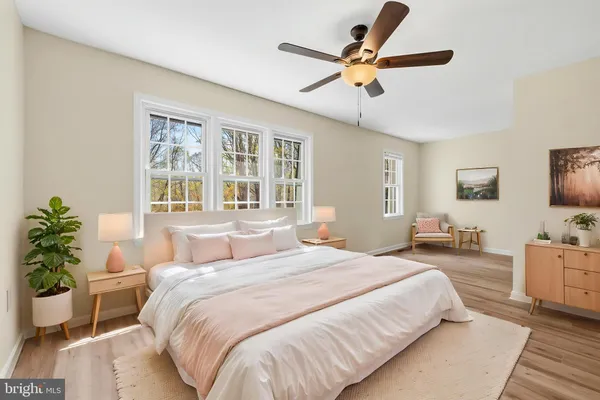 a bedroom with a large bed and a chandelier