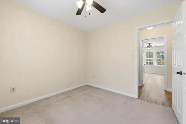 an empty room with a empty space and chandelier fan