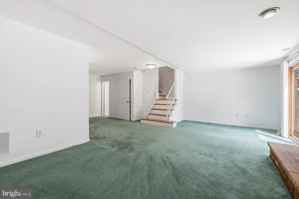 a view of a room with stairs and a window