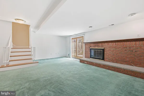 a view of an empty room with a fireplace