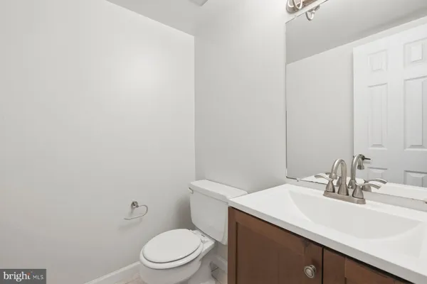 a bathroom with a sink a toilet and mirror