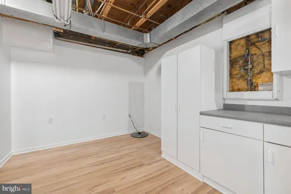 a view of a room with wooden floor and cabinet