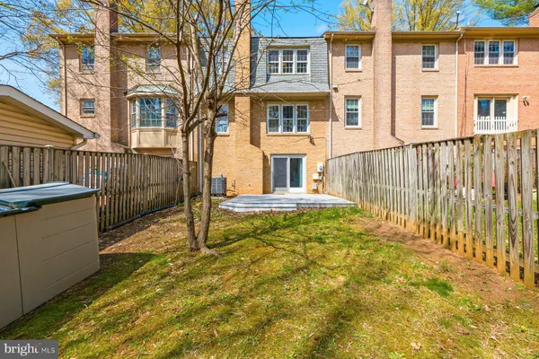 a view of a brick house with many windows