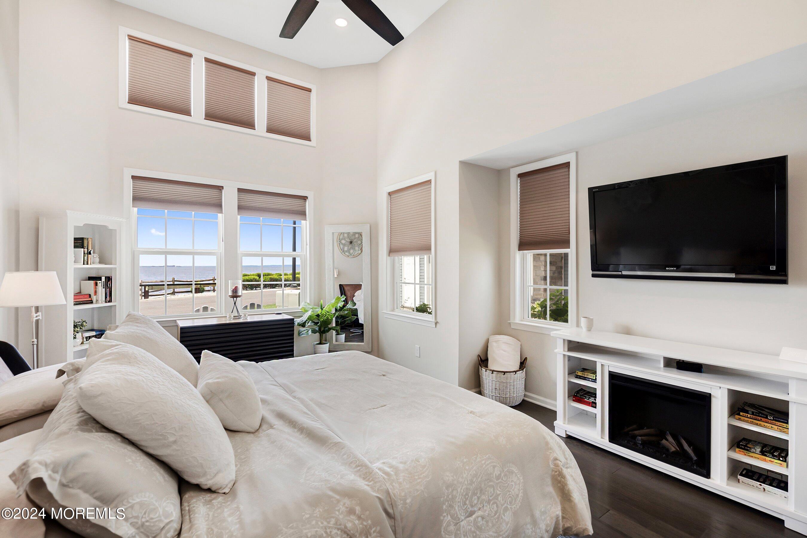 6 Lighthouse Point Road, Unit 701 Highlands, NJ 07732 - Photo 17 of 48 a bedroom with a bed and a flat screen tv