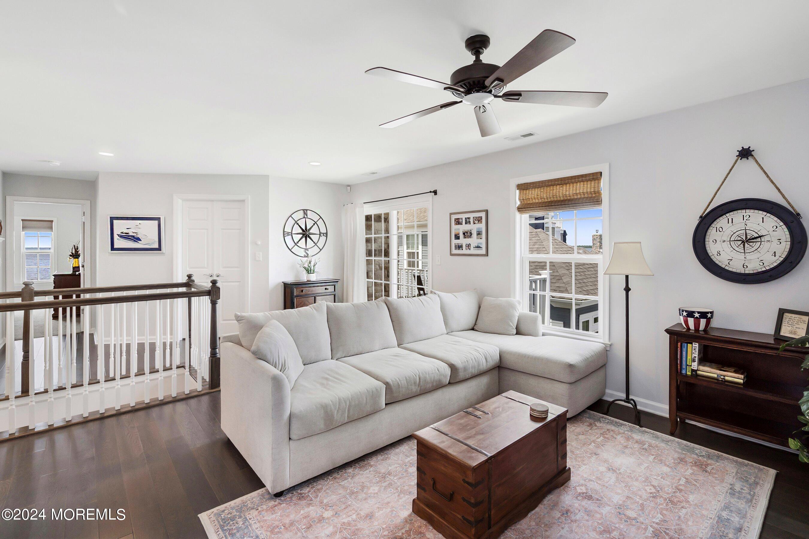6 Lighthouse Point Road, Unit 701 Highlands, NJ 07732 - Photo 22 of 48 a living room with furniture a clock on a wall and a window