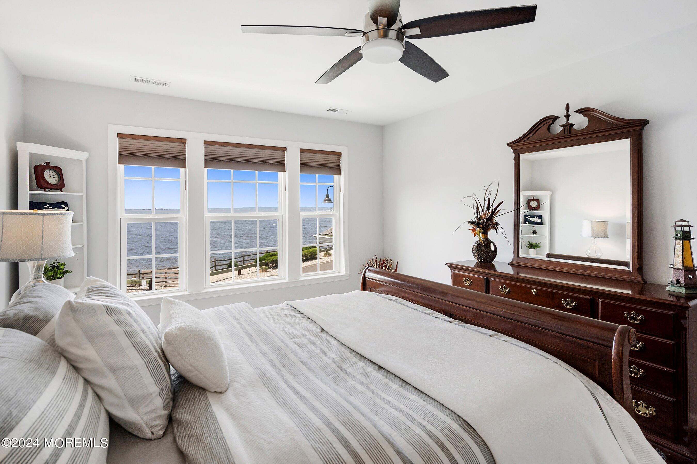 6 Lighthouse Point Road, Unit 701 Highlands, NJ 07732 - Photo 26 of 48 a bedroom with a bed and a large mirror on the dresser