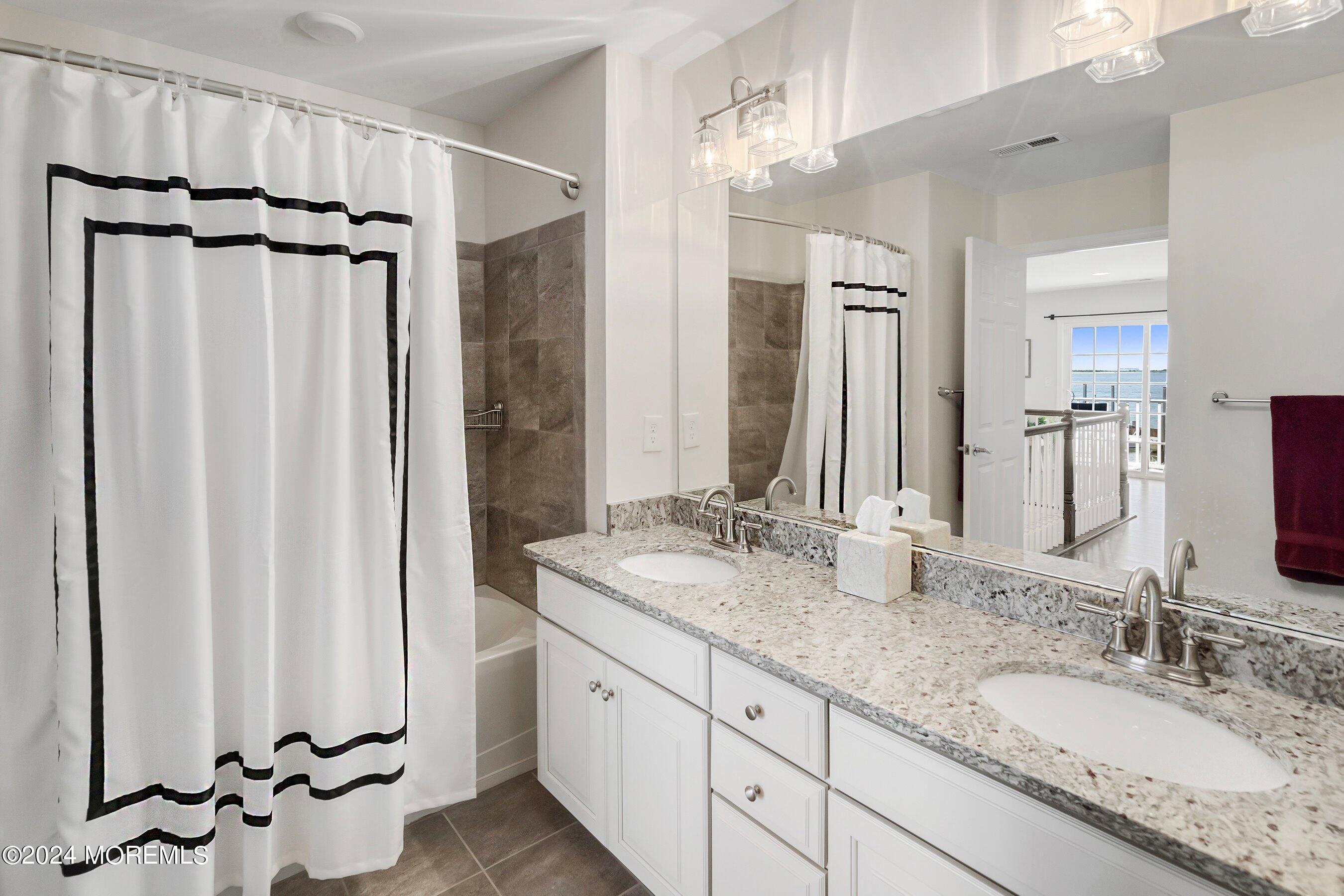 6 Lighthouse Point Road, Unit 701 Highlands, NJ 07732 - Photo 27 of 48 a bathroom with double sink and a mirror