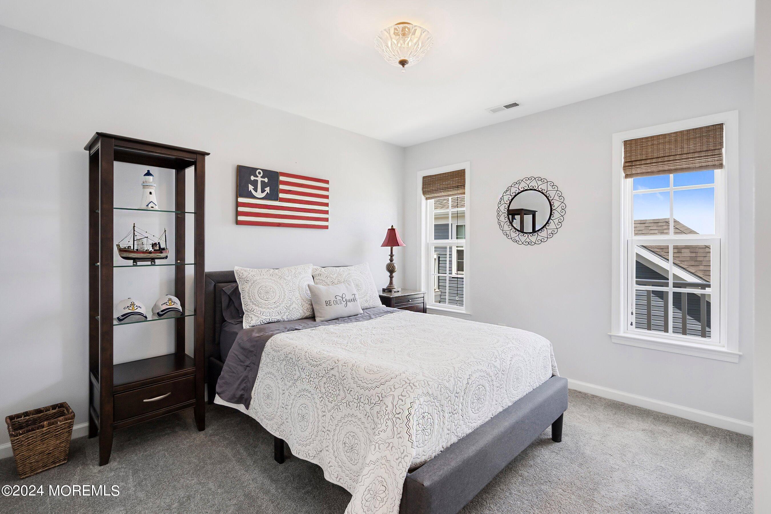 6 Lighthouse Point Road, Unit 701 Highlands, NJ 07732 - Photo 28 of 48 a bedroom with a bed and a window