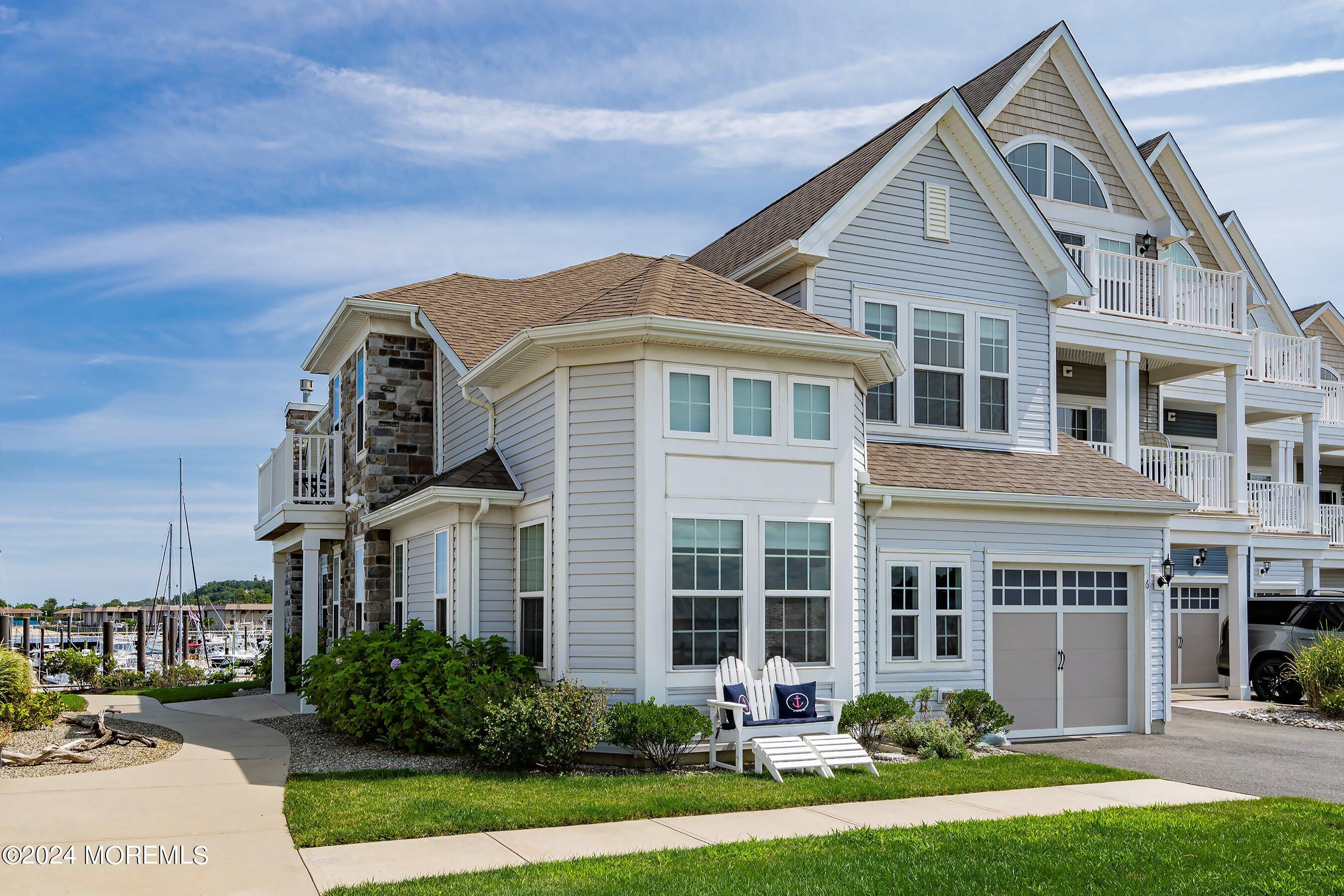 6 Lighthouse Point Road, Unit 701 Highlands, NJ 07732 - Photo 3 of 48 a front view of a house with a yard