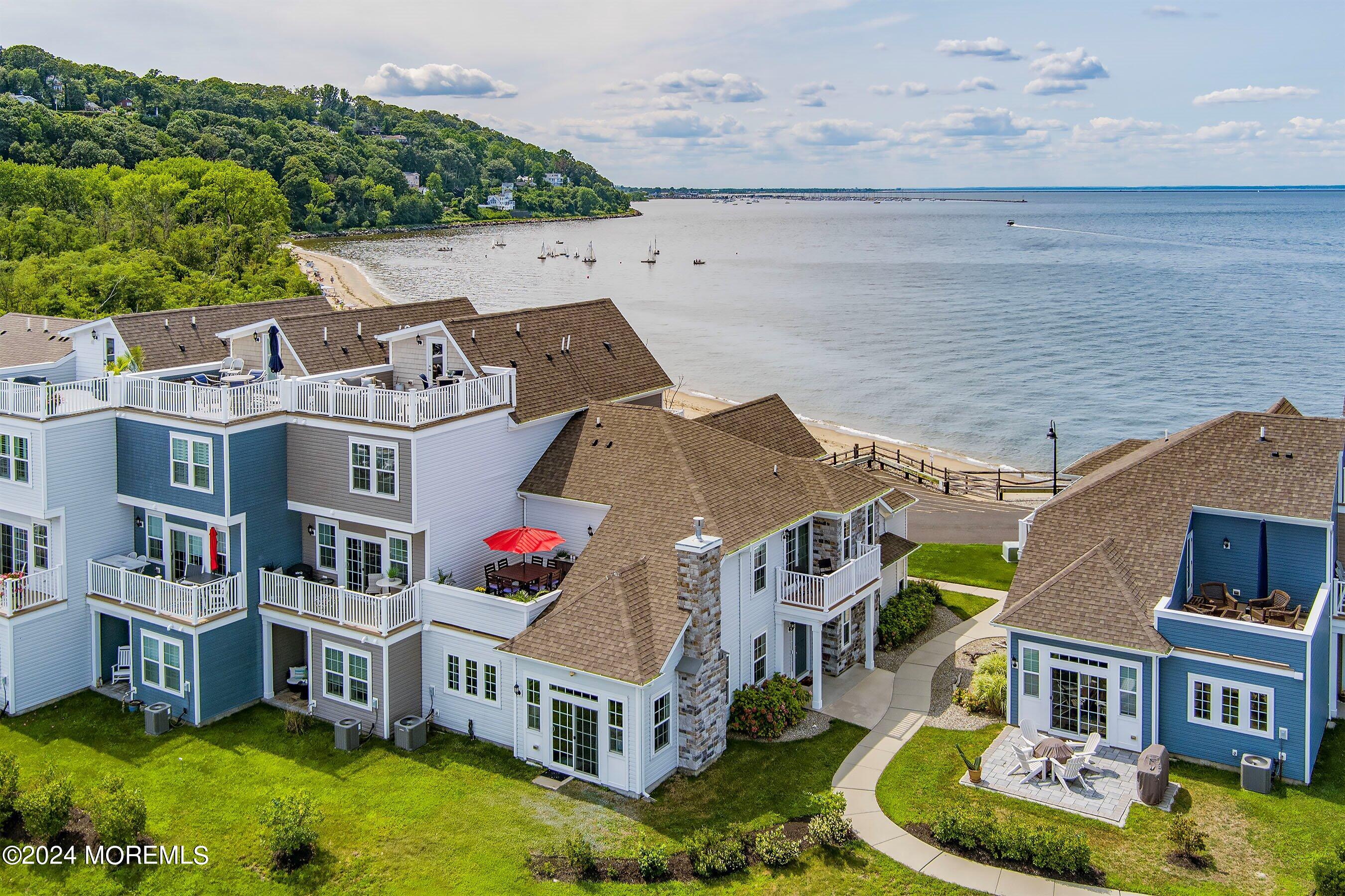 6 Lighthouse Point Road, Unit 701 Highlands, NJ 07732 - Photo 37 of 48 a aerial view of multiple houses with a big yard