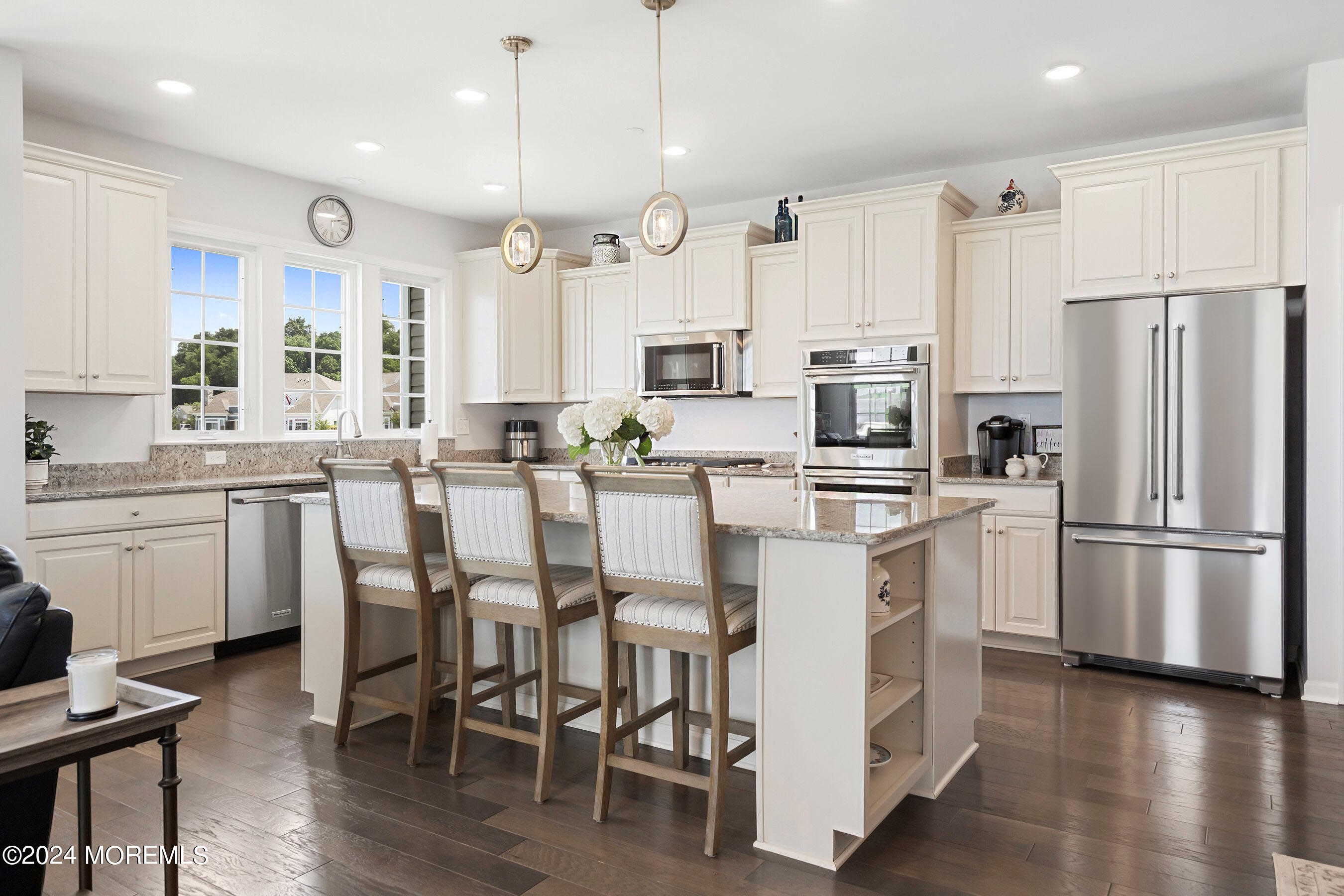 6 Lighthouse Point Road, Unit 701 Highlands, NJ 07732 - Photo 7 of 48 a kitchen with stainless steel appliances a refrigerator a stove a sink and white cabinets with wooden floor