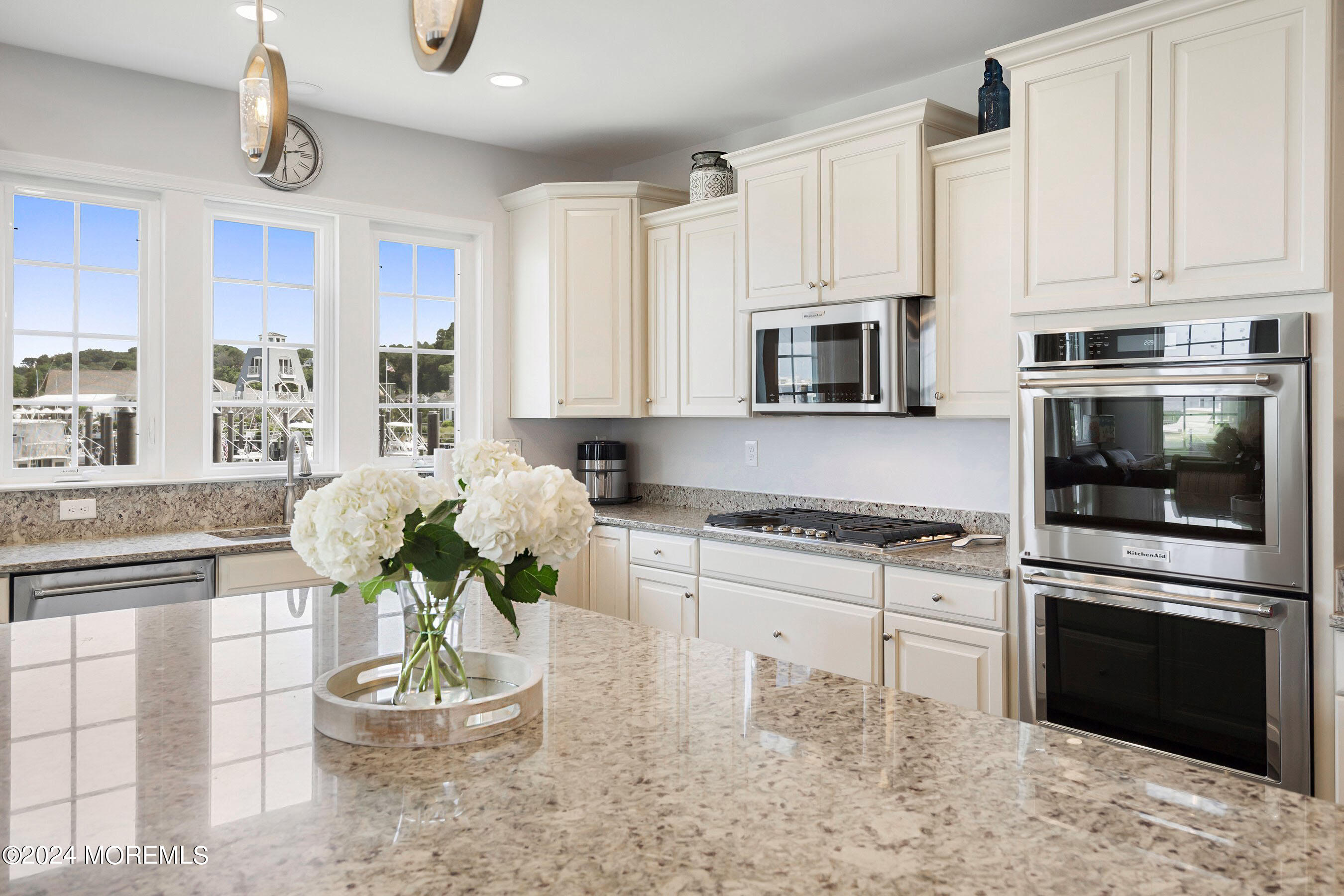 6 Lighthouse Point Road, Unit 701 Highlands, NJ 07732 - Photo 8 of 48 a kitchen with stainless steel appliances kitchen island granite countertop a stove a sink and a microwave