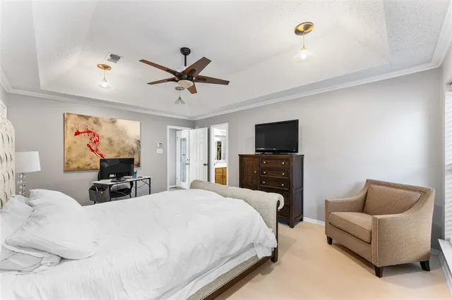 a bed room with a bed a couch and a chandelier