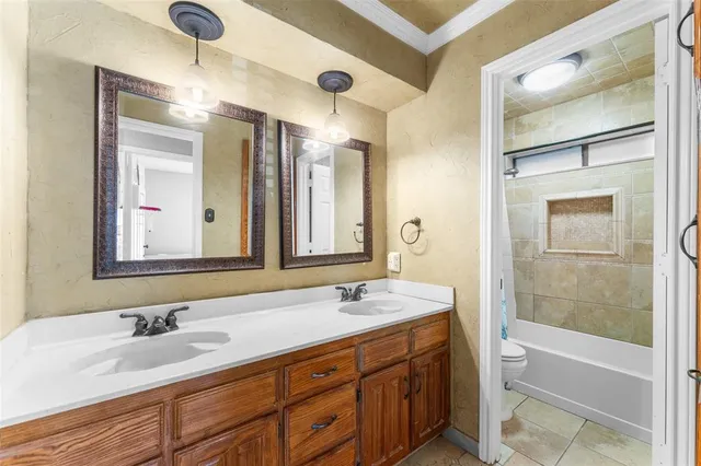 a bathroom with a tub sink and mirror