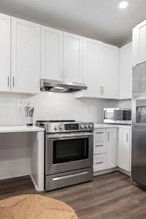 a kitchen with stainless steel appliances kitchen island granite countertop a sink and cabinets