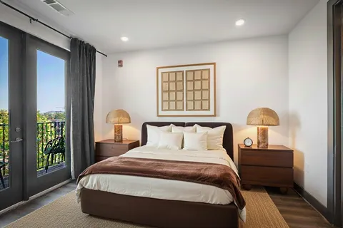 a bedroom with a bed and a window