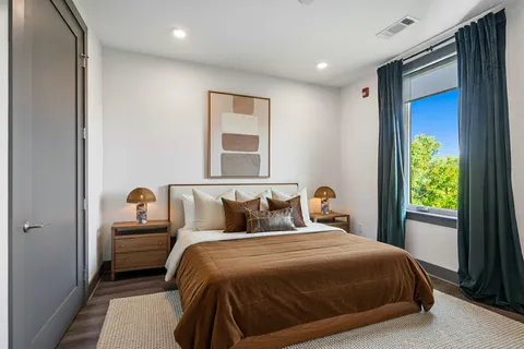 a roof deck with couches and city view