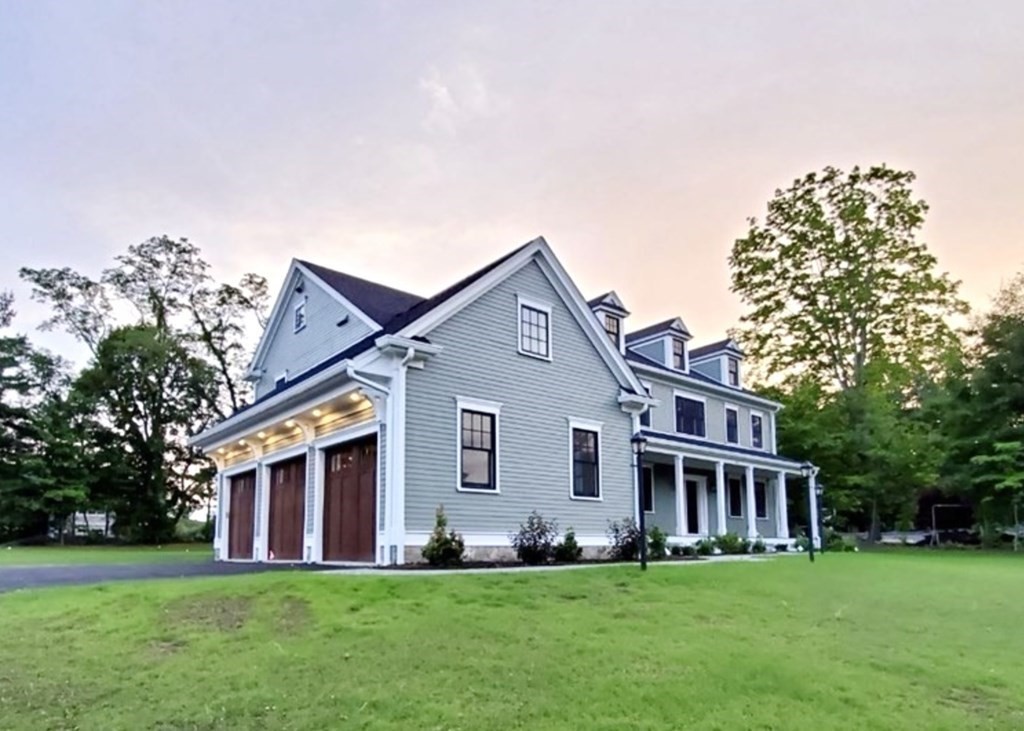 a front view of house with yard and green space