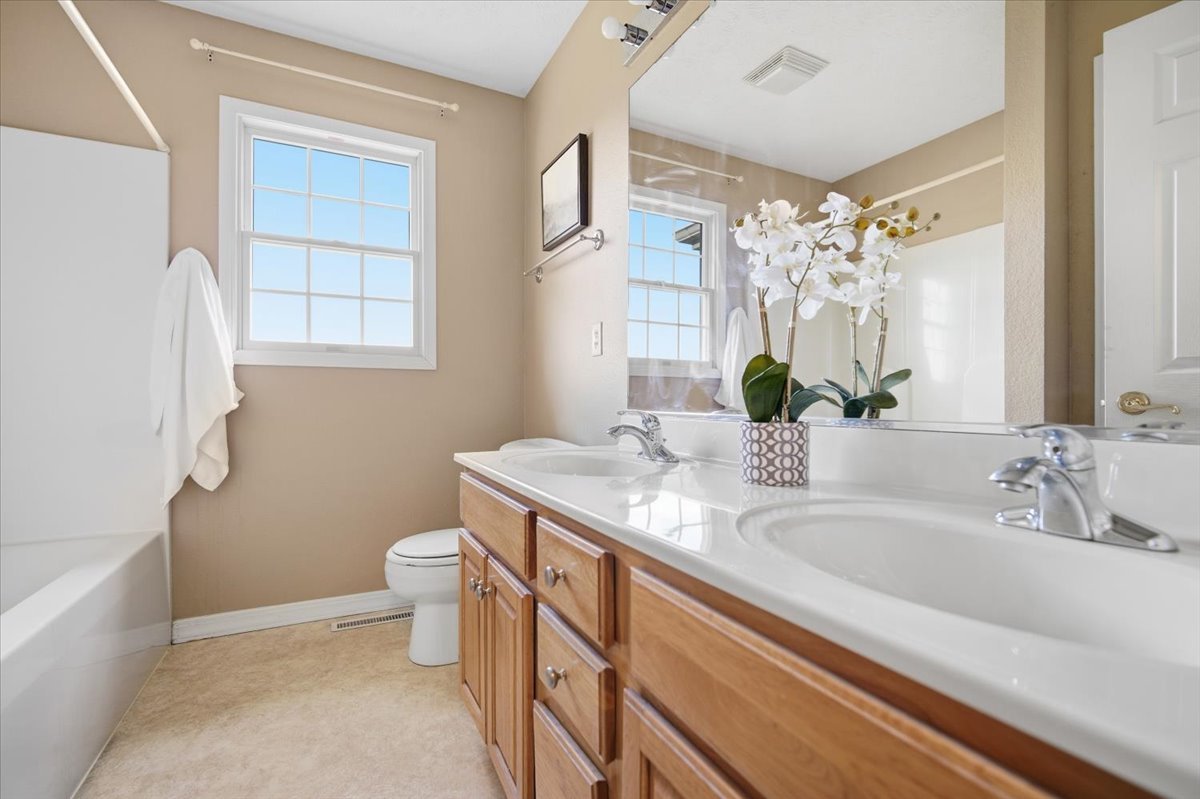 3255 Fire Fly Court Normal, IL 61761 - Photo 18 of 25 a bathroom with a granite countertop sink a toilet and bathtub
