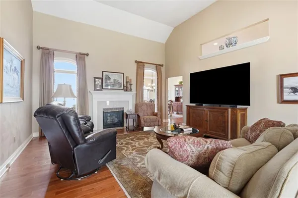 a living room with fireplace furniture and a flat screen tv