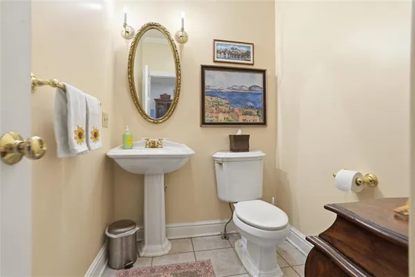 a bathroom with a toilet a sink and a mirror