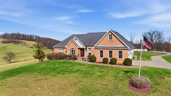 a view of house with yard and entertaining space