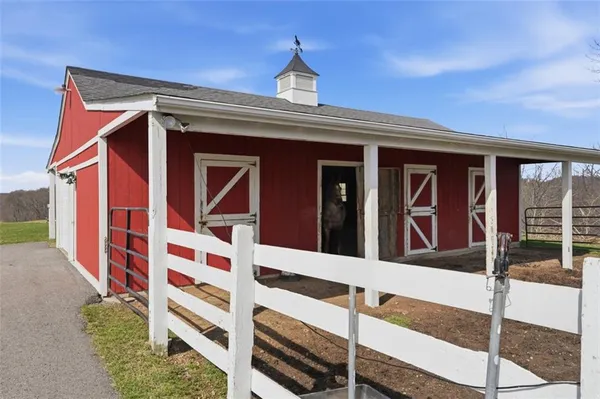 a view of a brick house with large windows