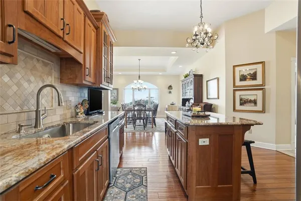 a kitchen with sink stove and dining table