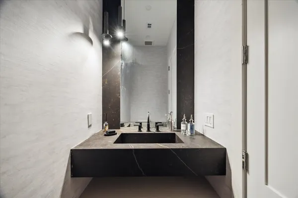 a bathroom with a sink and a mirror