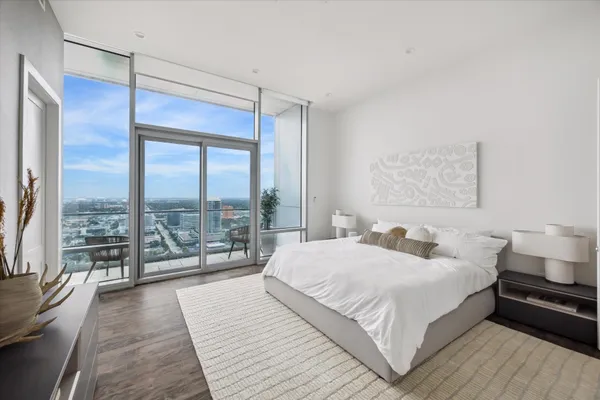 a bedroom with a large bed and a large window