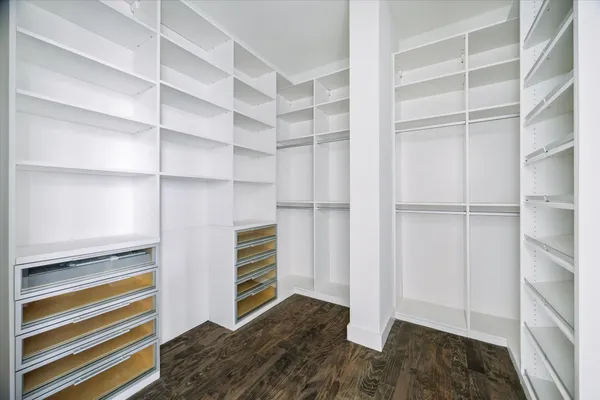 a view of walk in closet with empty racks
