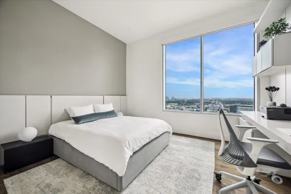 a bedroom with a bed and a view of balcony