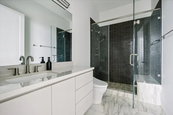 a bathroom with a shower sink and toilet