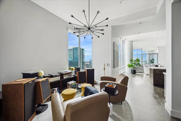 a living room with furniture a chandelier and a window