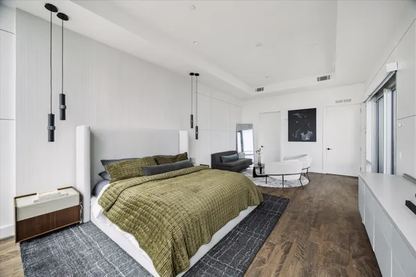 a bedroom with a bed and wooden floor