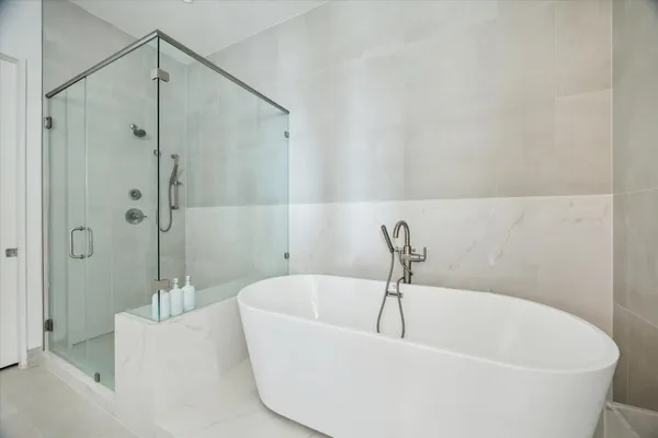 a bathroom with a bathtub and shower