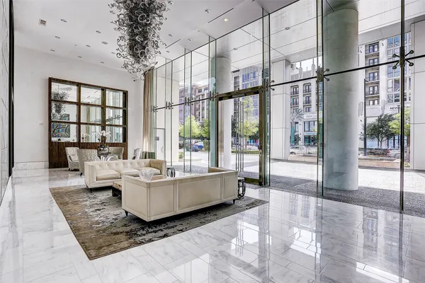 a living room with fireplace furniture and floor to ceiling window