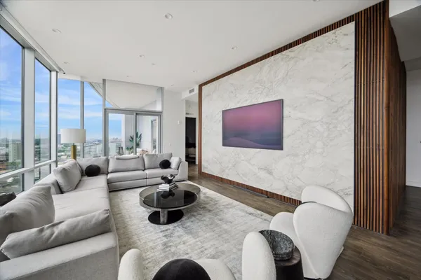 a living room with furniture or couch and a large window