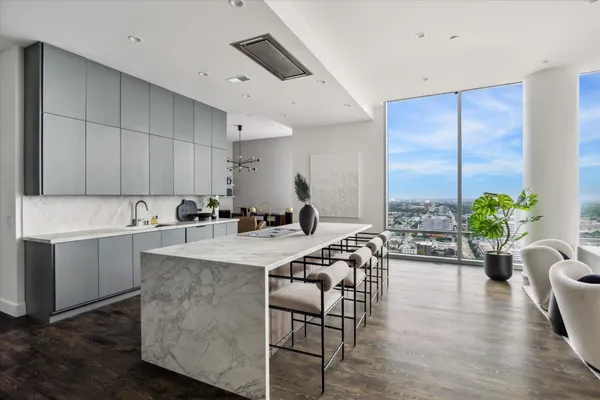 a large white kitchen with a large window