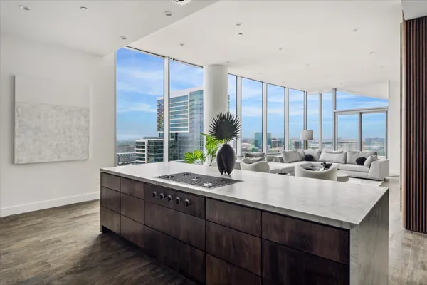 a kitchen with kitchen island granite countertop a sink and a counter top space