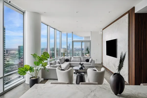 a living room with furniture potted plant and a window
