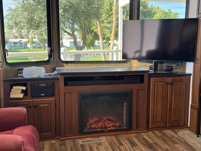 a dining hall with couches a flat screen tv and a coffee table