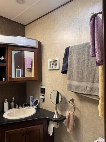 a bed room with a bed and a refrigerator