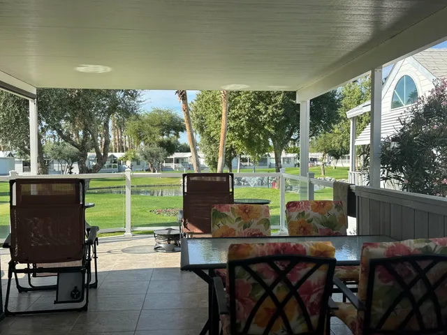 a view of a porch with chairs and backyard